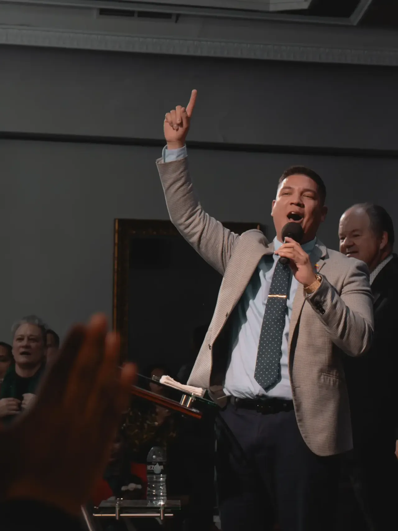 Un líder de alabanza canta con la mano alzada durante un culto en Tabernáculo de Vida Madrid
